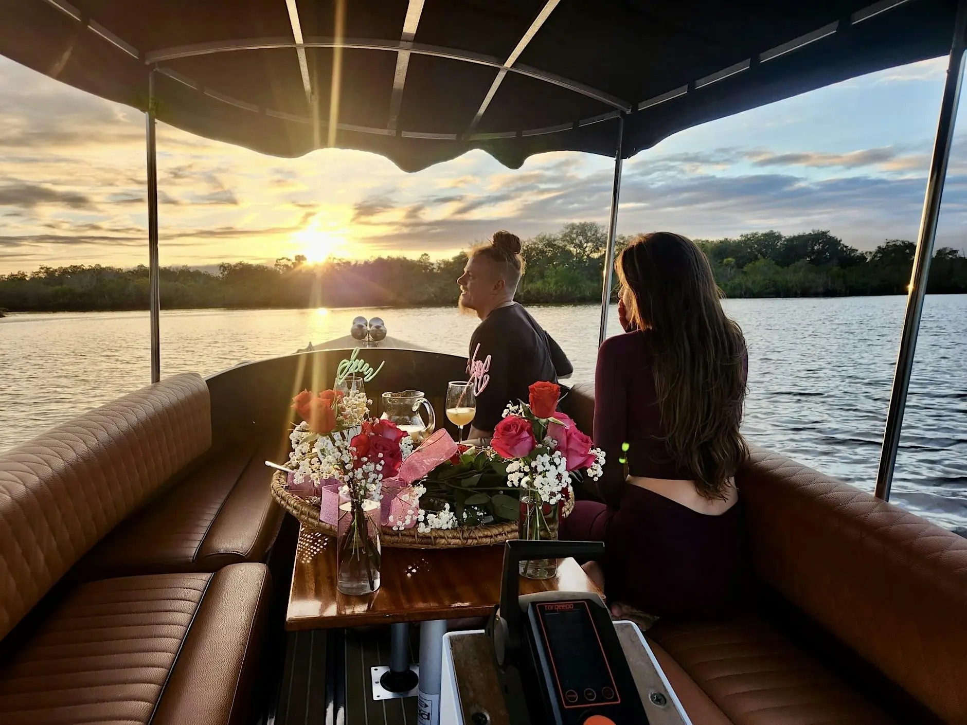 A small table on a boat at sunset.